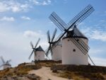 Picturesque scene of historic Spanish windmills under a clear sky.