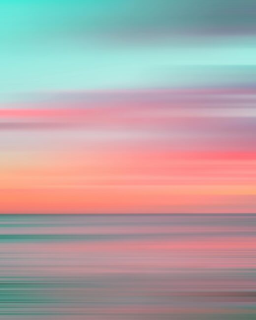 Colorful motion blur capturing a stunning Hawaiian sunset over the ocean.
