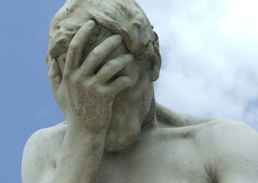 A dramatic close-up of a renowned statue in Paris expressing frustration.