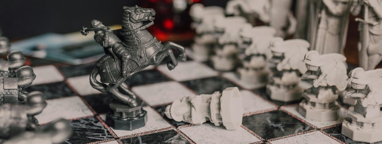 Close-up of a fantasy-themed medieval chess set with intricate details, highlighting a knight piece.