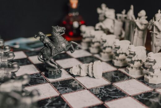 Close-up of a fantasy-themed medieval chess set with intricate details, highlighting a knight piece.